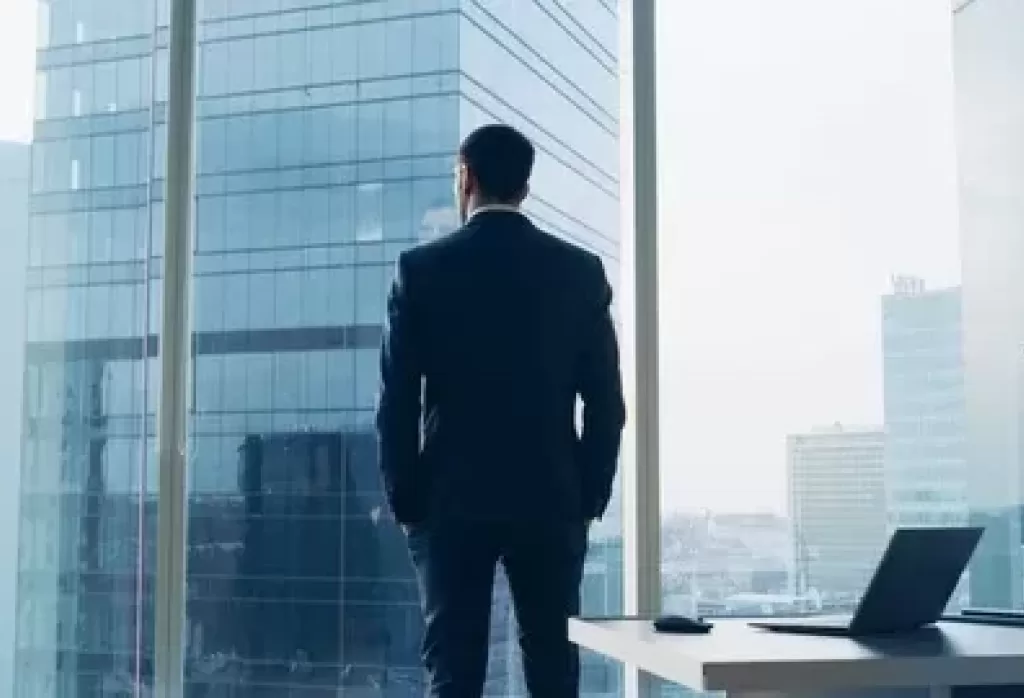 Businessman looking out office window footage 092787553 iconl